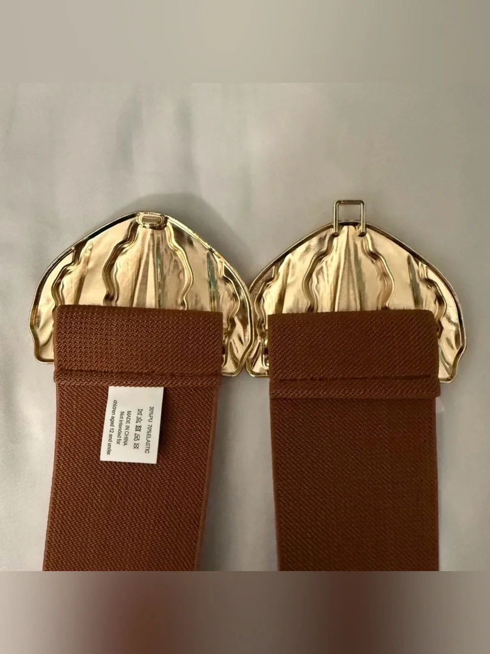 Brown elastic waistband belt with gold tone butterfly buckle
